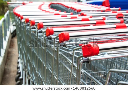 Row of empty shopping carts. Parking at the supermarket. Shopping symbol. Metal carts.