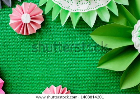 Flower made of paper for green background texture