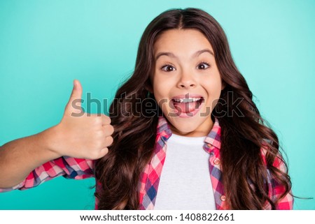Portrait of trendy astonished kid impressed by incredible news ads choice decision recommend positive scream shout omg wow dressed checked shirt modern isolated green background