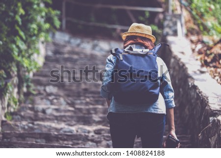 young girl asian carrying  travel backpack alone