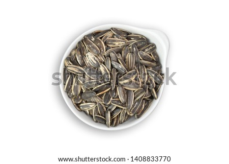 top view of Sunflower seeds in white ceramic bowl isolated on white background view. Flat lay. Clipping path.