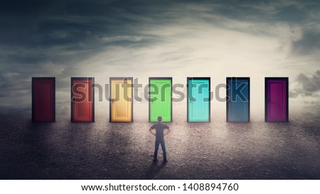 Confident guy in front of many doors different colored has to choose one. Difficult decision, important choice concept, failure or success. Ways to unknown future, career development opportunity. Royalty-Free Stock Photo #1408894760