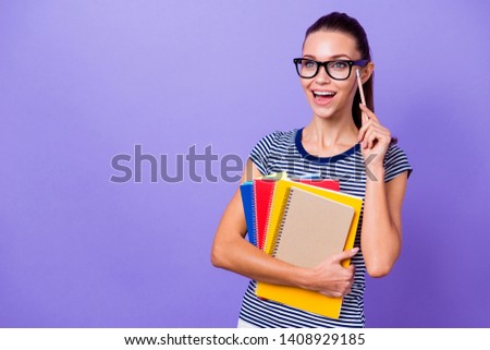 Portrait of her she nice-looking attractive lovely charming cute intelligent cheerful cheery girl holding in hands books pointing pencil isolated over violet purple vivid shine bright background