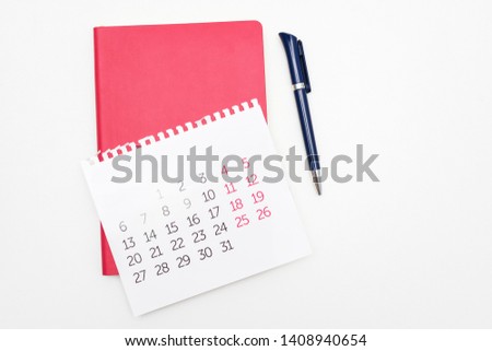 Calendar, pen and red notebook, white desktop, copy space, for recording, close up, top view