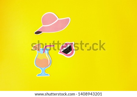 Photo booth props hat, lips and cocktail on yellow background. Stylish lady face created from summer props hat and lips. Summer concept, party set. Top view. Flat lay. Copy space. 