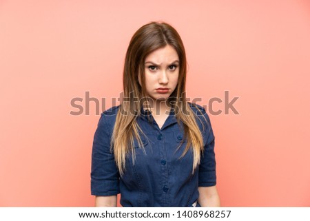 Teenager girl over isolated pink background with sad and depressed expression