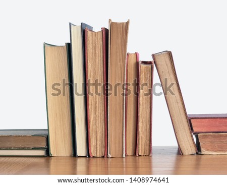 Old books on a wooden shelf