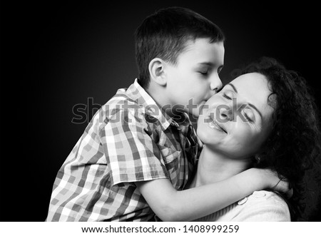 Happiness mother and child, son kisses his mom