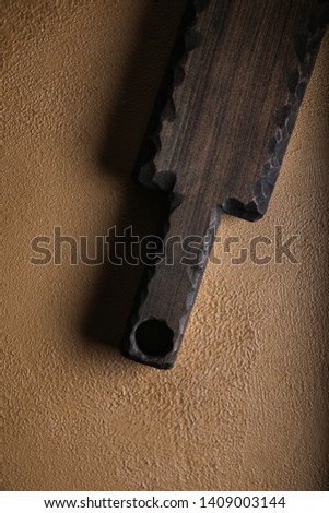 Wooden cutboard on colorful abstract concrete textured backgraund. 