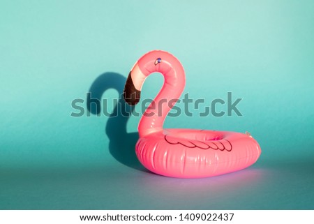 Giant inflatable Flamingo on a blue background, pool float party, trendy summer concept