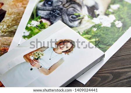 Photo canvas prints. Sample of stretched photography of woman with gallery wrap. Printed photos of a dog and a wedding couple lying on a table