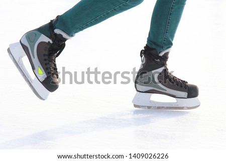 Feet skating on the ice rink. Hobbies and recreation. Sports and holidays

 