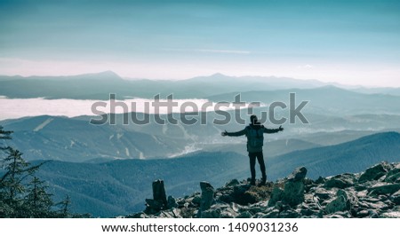 Happy hiker winning reaching life goal, success, freedom and happiness, achievement in mountains. Lifestyle wanderlust adventure. Carpathian mountains, Ukraine, Europe