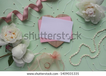 wedding card design. white peonies, wedding ring and envelope on a wedding