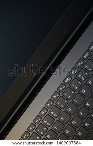 Laptop monitor and keyboard in triangle orientation asymmetric image