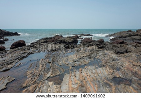 Anjuna beach in the northern Goa, India. Popular beach vacations destination in Goa. Details of coastline.