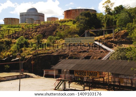 Abandoned Oil Tanks Site. Note 1: Sign on top of rock reads saying from the Bible: “I can do all this through him who gives me strength.” Philippians 4:13.  
Note 2: Sign under roof: “No Smoking”.