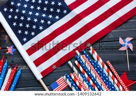 Close up Wooden calendar 4th of July day of American independence, decorations,  flag, candles, straws. USA holiday decorations on a wooden background, top view, flat lay 