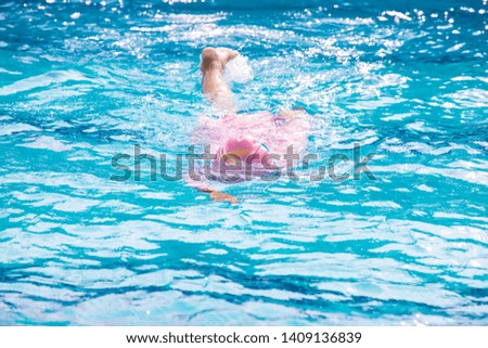 child swimming on swimming pool, summer activity.