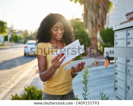 african american woman checking mail in las vegas community Royalty-Free Stock Photo #1409155793