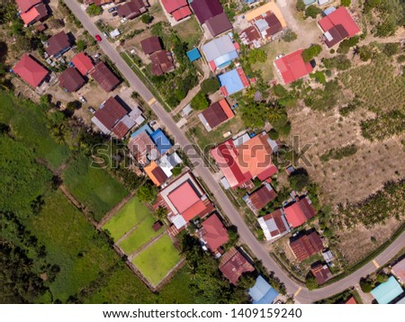 Beautiful Nature landscape Aerial image of green paddy and small village houses in rainforest at Tambunan, Sabah Boneo