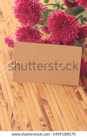 Fresh purple flowers and empty tag for your text