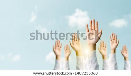 Group of hand businessmen raised the sky with sunlight. International volunteer day and human rights day. People voted concept Royalty-Free Stock Photo #1409235368