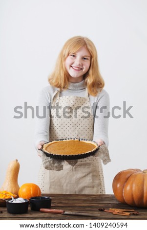 woman cooks pumpkin pie on white background