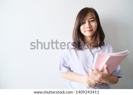the asian woman holding books