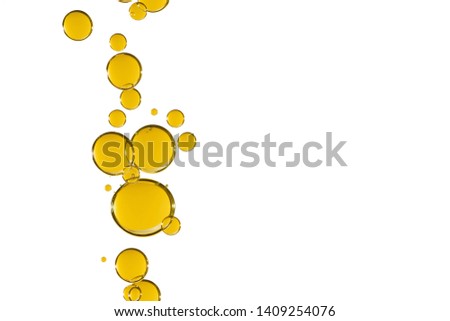 Yellow liquid bubbles is falling over a white background.