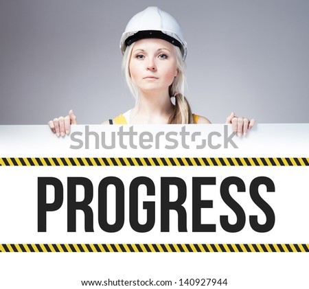 Worker holding progress sign placed on information board
