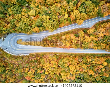 Scenic Mohawk Trail highway hairpin turn in autumn, Massachusetts, USA. Fall in New England. Aerial drone shot.  Royalty-Free Stock Photo #1409292110