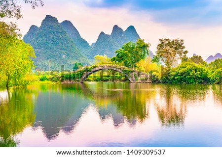 Landscape of Guilin, Ancient Bridge and Karst mountains. Located near Yangshuo, Guilin, Guangxi, China.