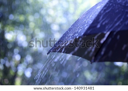 Rain drops falling from a black umbrella Royalty-Free Stock Photo #140931481