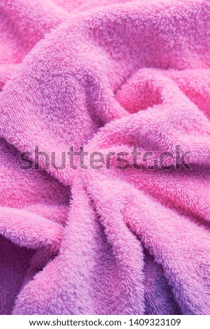 Texture of soft tissue fibers. Close-up.Fluffy Gentle baby fabric with waves and folds. Soft pastel textile texture. Folds on the soft fabric. Rose towel terry cloth.