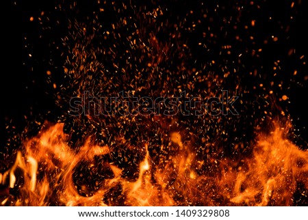 Detail of fire sparks isolated on black background. Abstract flaming background