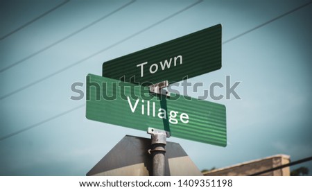 Street Sign the Direction Way to Village versus Town