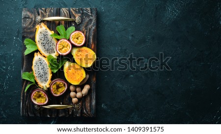 Tropical Fruits - Cactus and dragon fruit on a wooden background. Top view. Free space for text.