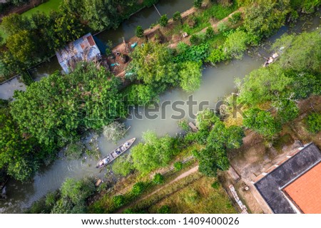 Aerial view of tourists from China, Korea, America, Russia experiencing a basket boat tour at Tan Phong island or Cu Lao Tan Phong in Tien Giang, Vietnam. Near My Tho city.