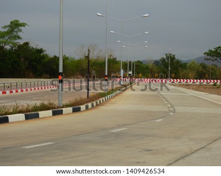 The empty cement road with a light pole