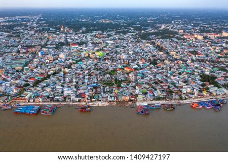 Aerial view of My Tho city center with development buildings, transportation, energy power infrastructure in developed Mekong Delta. The boats are anchored. View from MeKong river. Tien Giang, Vietnam