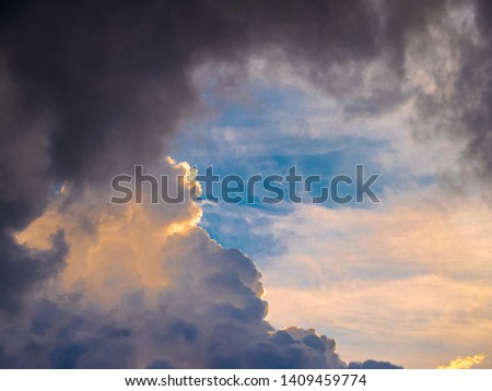 Heavy thunderclouds, illuminated from the inside by orange sunlight. Dramatic picture of nature.