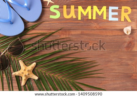 accessories for the beach and the word "summer" on a colored background top view.

