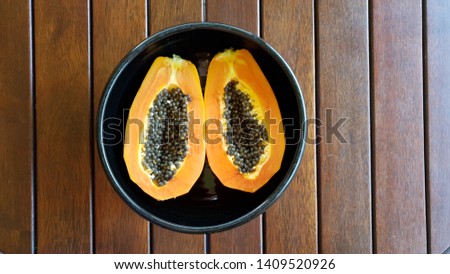 Cut Red Papaya with seeds in Black Bowl,