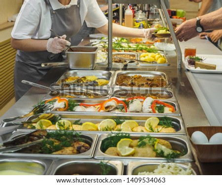 Cuisine cafeteria buffet with food. Self-service food display showcase. Royalty-Free Stock Photo #1409534063
