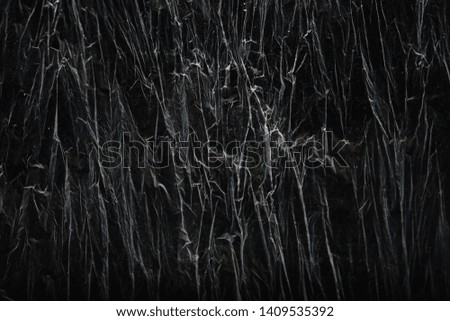 a crumpled transparent plastic on a dark background