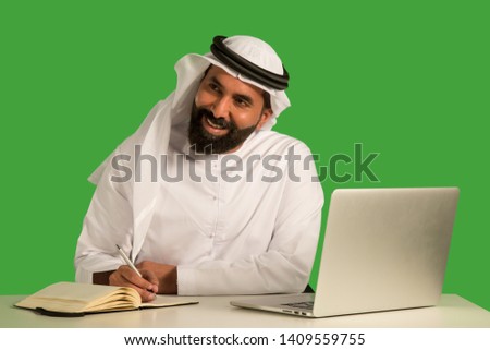 Emirati man working on a laptop.