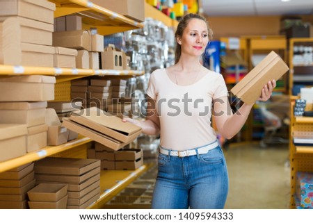 Brunette girl with gift boxes in her hands in store