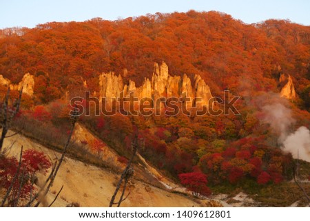 Beautiful Autumn leaves red and yellow in the volcano . This place is a famous tourist spot and national park in Noboribetsu city japan . When October is coming with color and smoke from valley 
