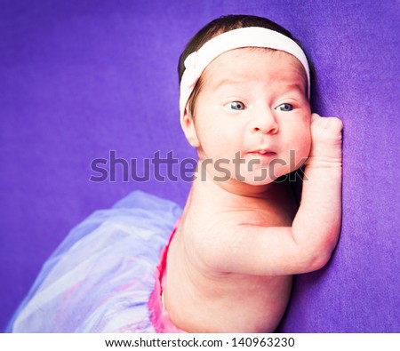 Little cute baby girl on a colored background